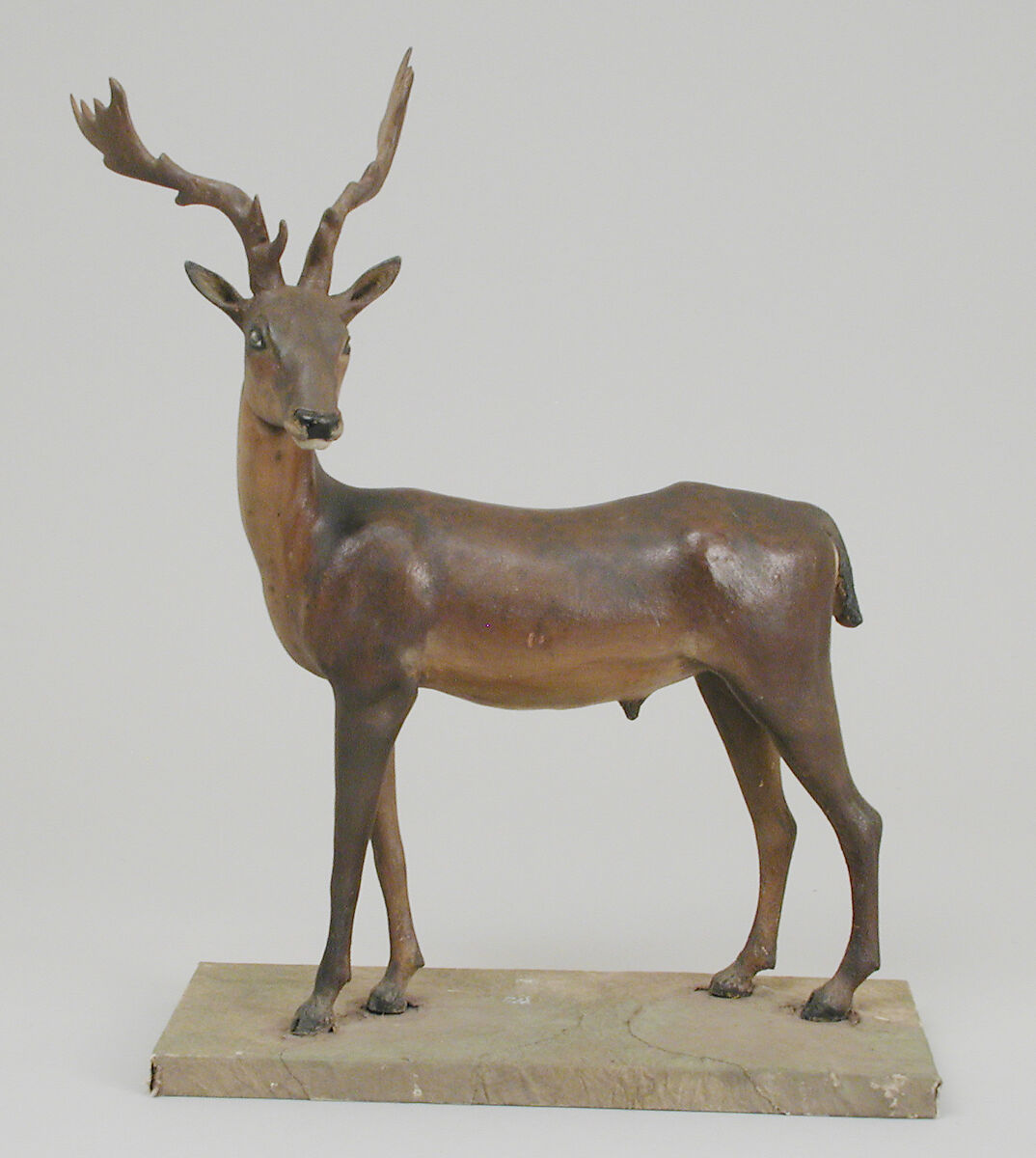 Antlered buck, Polychromed terracotta body; wooden legs and horns; glass eyes