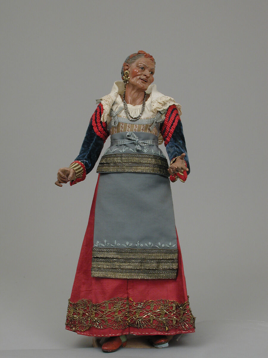 Old woman carrying a wire basket, Polychromed wood and terracotta; silk, linen, straw, steel