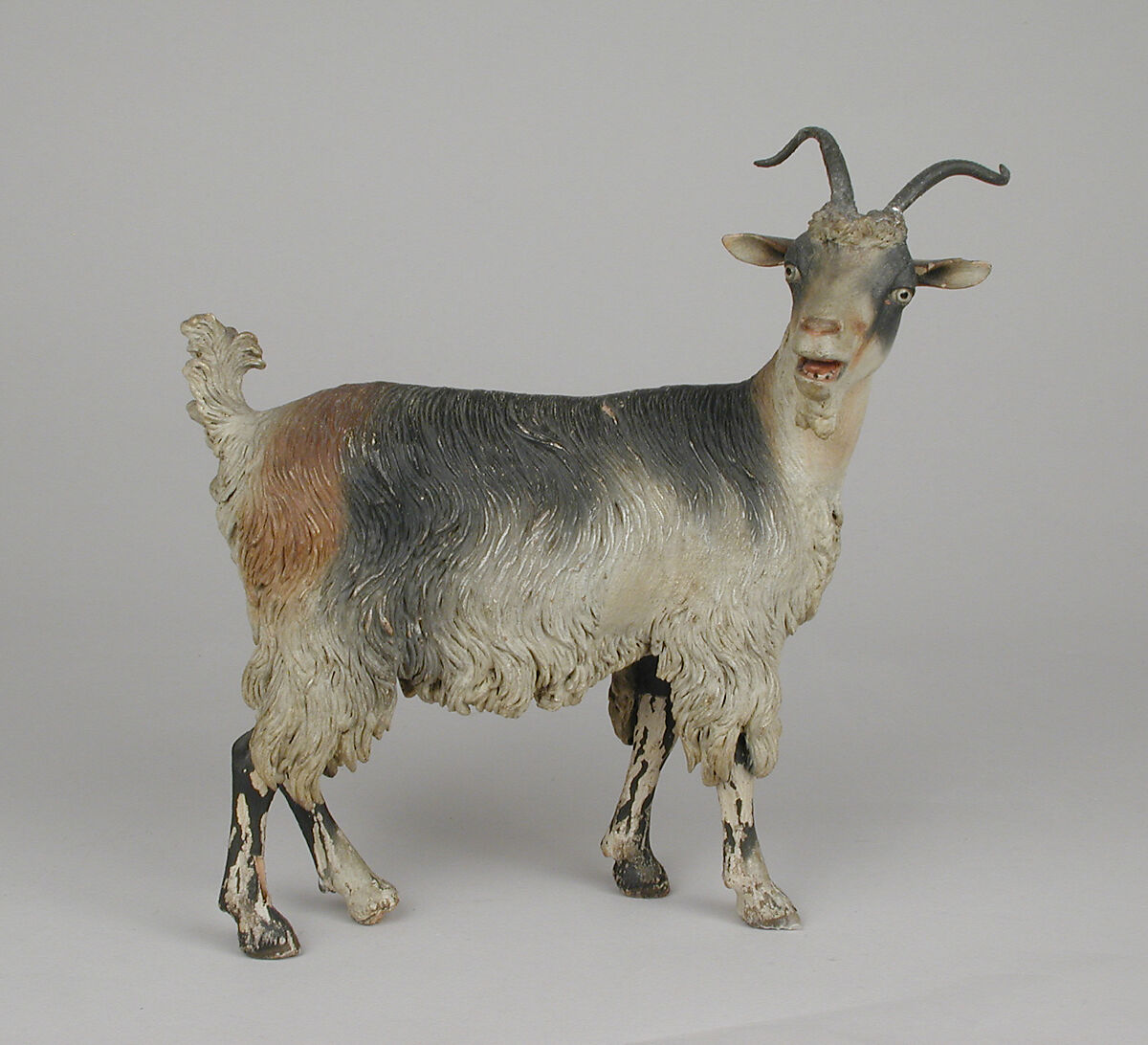 Female adult goat, Polychromed terracotta body, wooden legs, metal horns