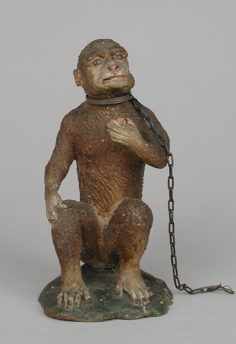 Seated monkey, Polychromed terracotta body; silver collar and chain