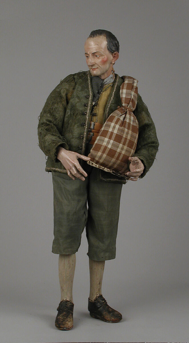 Shepherd with lamb in shoulder bag, Polychromed terracotta head and lamb; wooden limbs; body of wire wrapped in tow; silk, cotton and suede garments; silver metal coiled wire buttons and gold vest