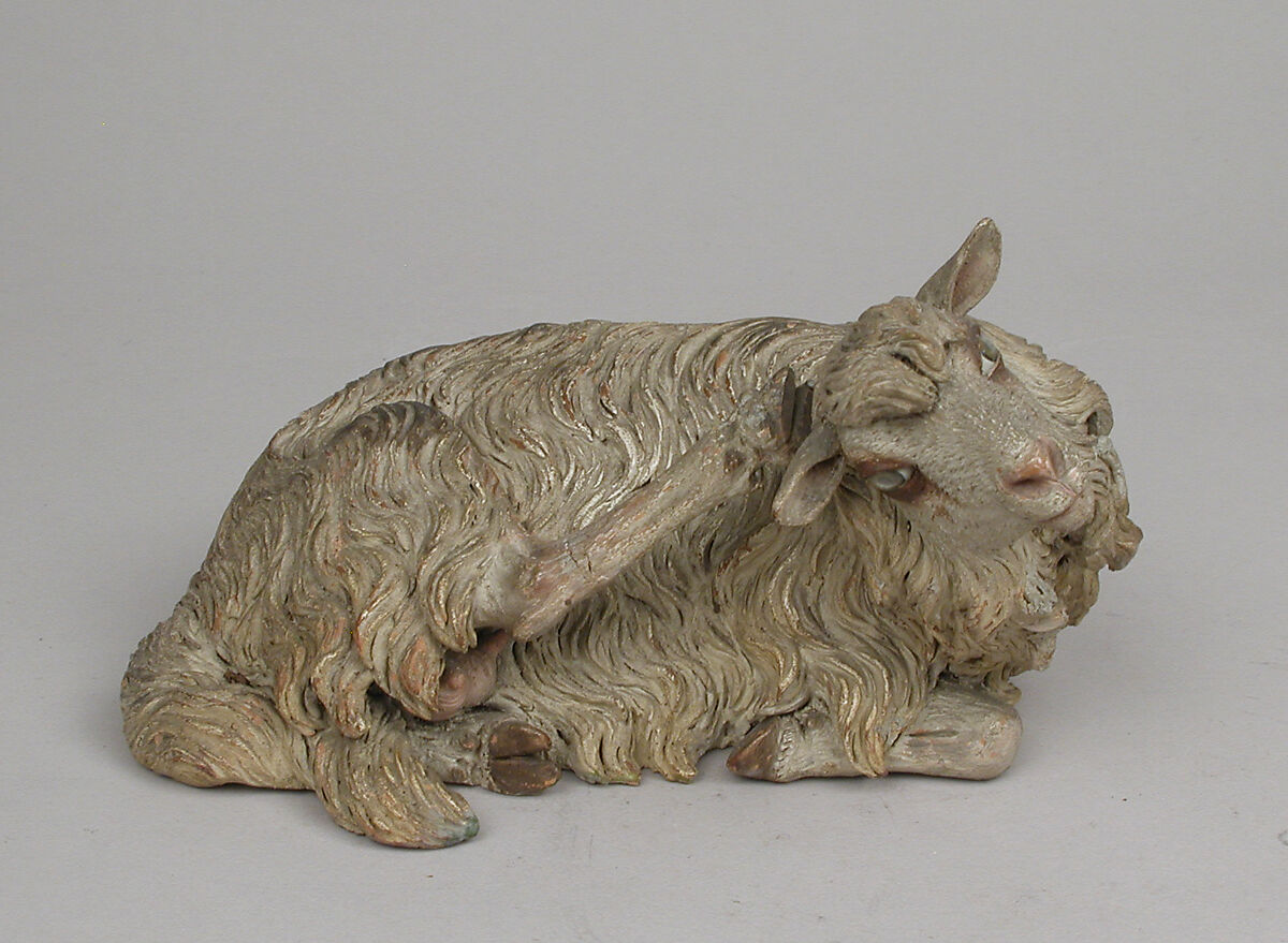 Reclining sheep, Polychromed terracotta body; wooden ears and raised leg