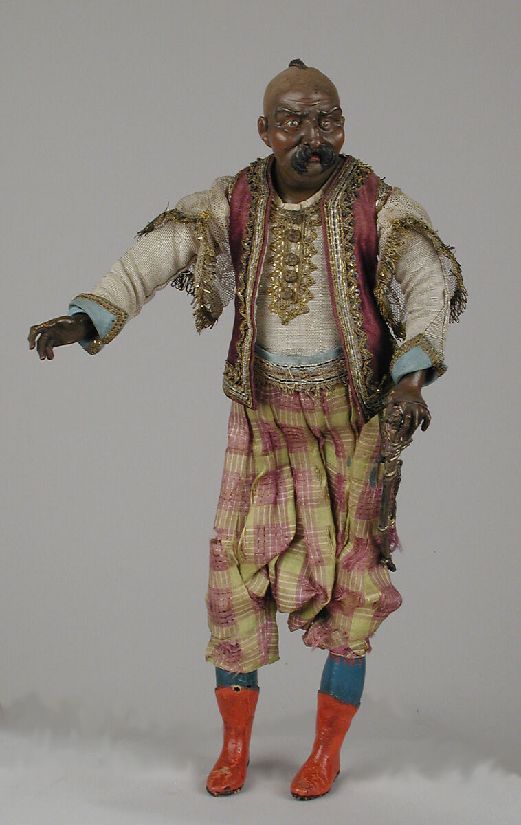 King's attendant, Polychromed terracotta head; wooden limbs; body of wire wrapped in tow; silk garments with silver and gold thread and buttons; gilt-metal sword