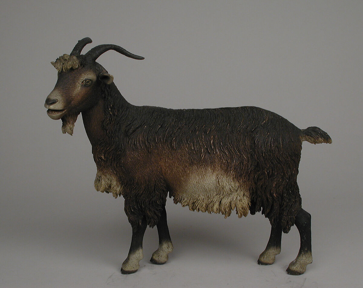 Standing female goat, Polychromed terracotta body with wooden ears and horns; lead eyes