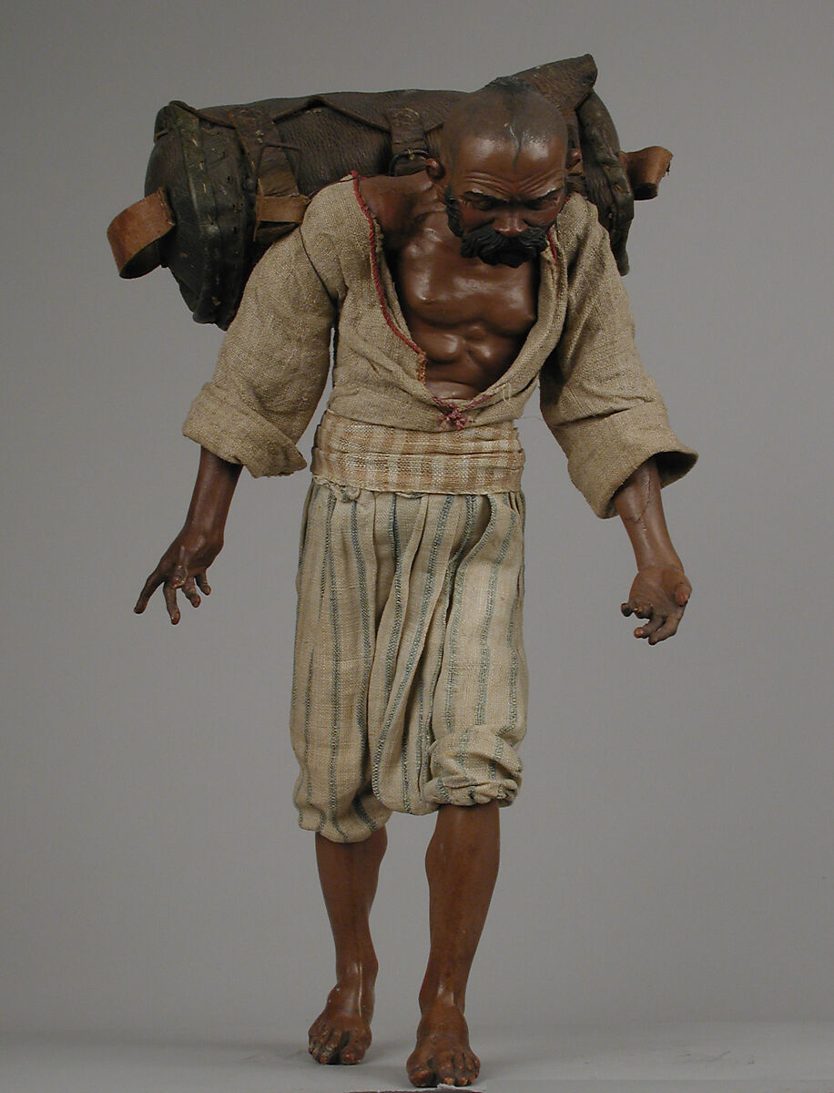 Man with back pack, Polychromed wood and terracotta; cloth, metal and leather