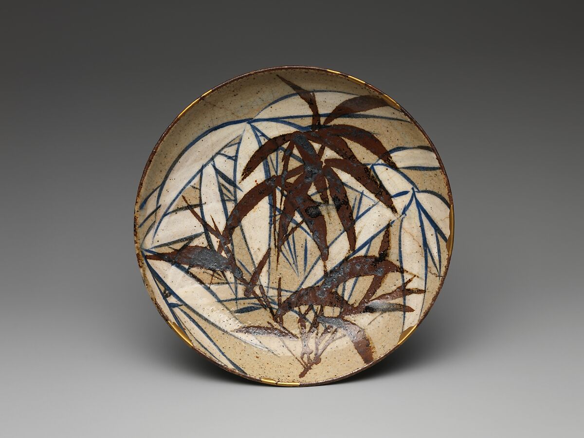 Dish with Bamboo Leaves
, Ogata Kenzan 尾形乾山, Stoneware painted with cobalt blue, cream and iron‑brown slip under a transparent glaze; gold lacquer repair (kintsugi), Japan