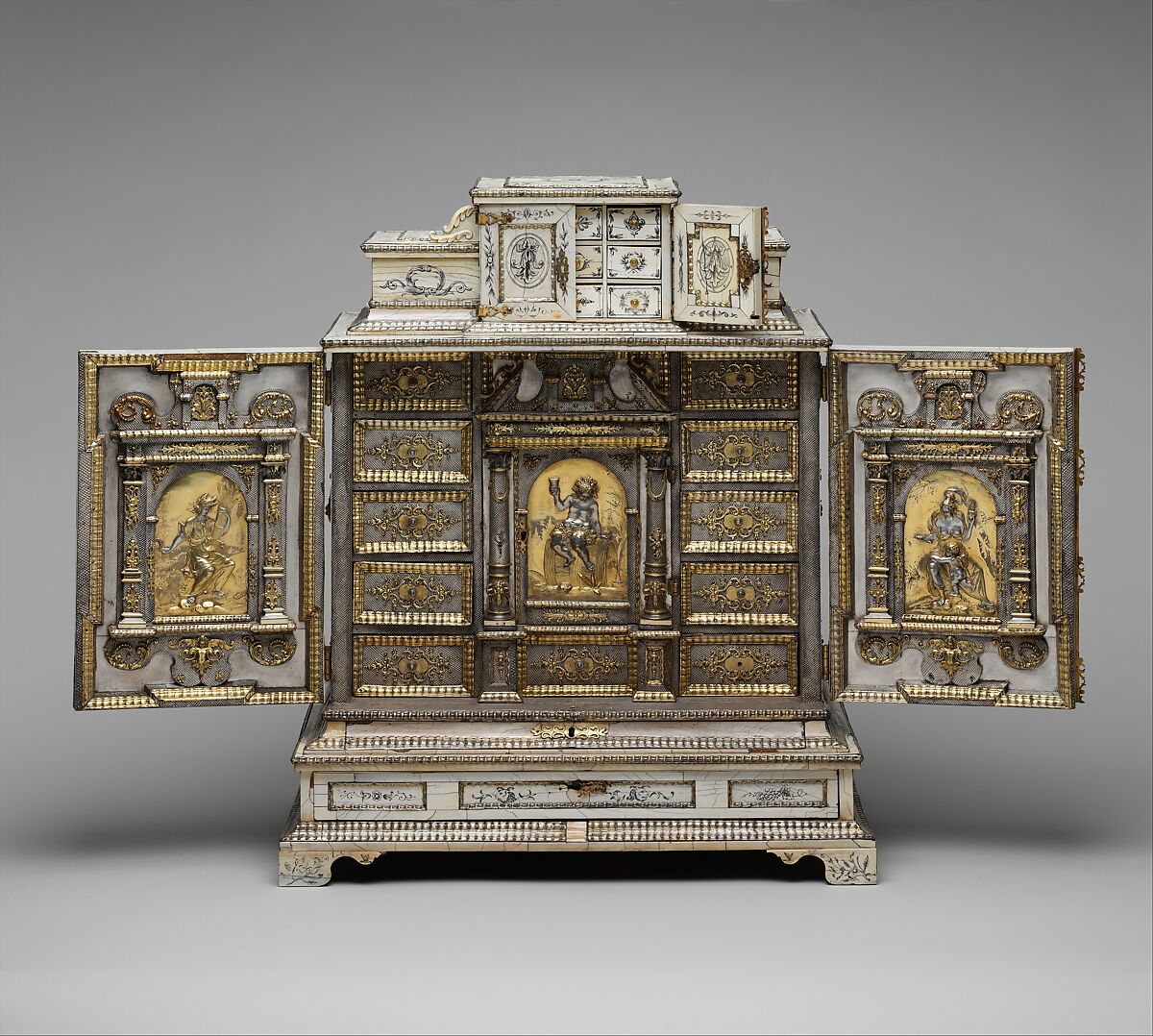 Cabinet, Cabinetry by the workshop of Melchior Baumgartner (German) (1621–1686), Oak, pine, walnut, cedar, ebony, and rosewood; ivory veneer and silver veneer; silver; silver-gilt moldings; gilded yellow-metal mounts; the drawers lined with aquamarine-colored silk, German, Augsburg 