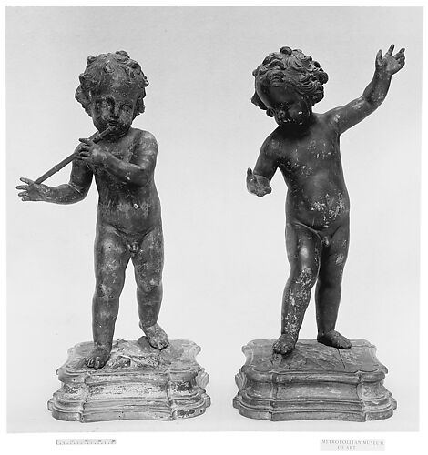Nude child playing a flute (one of a pair)