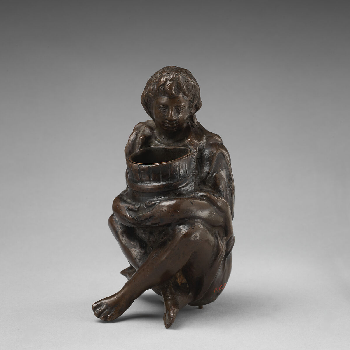 Boy with a barrel, Bronze, brown patina, on base of yellow marble with grey veining, probably Italian