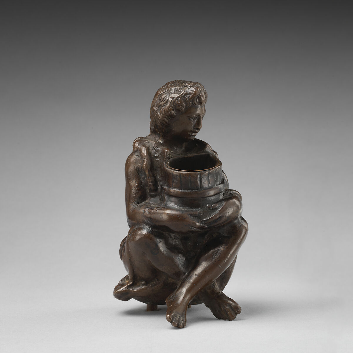 Boy with a barrel, Bronze, brown patina, on base of yellow marble with grey veining, probably Italian 
