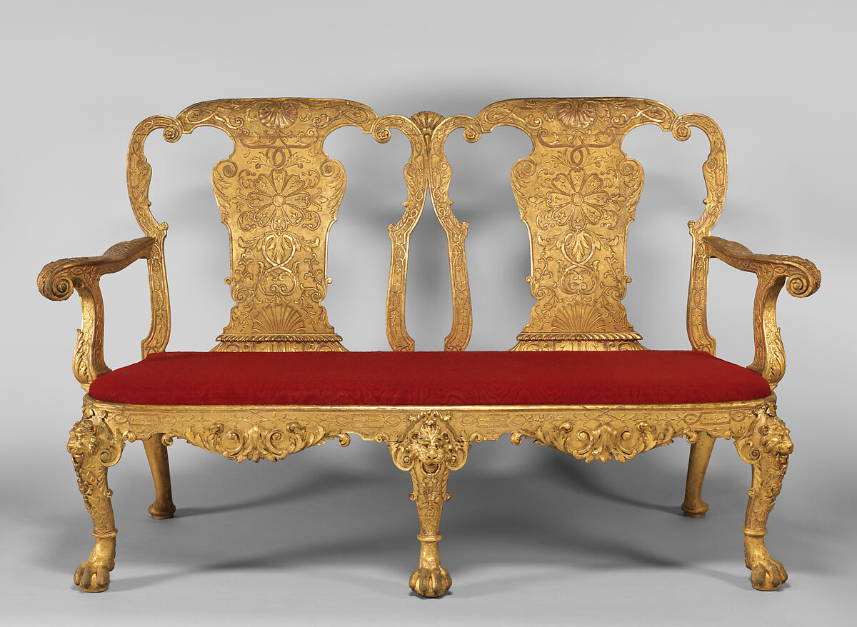  Gilded gesso on walnut; previously covered in eighteenth-century red silk damask not original. A golden two-person chair with a red cushion, which was likely designed by Benjamin Goodison.