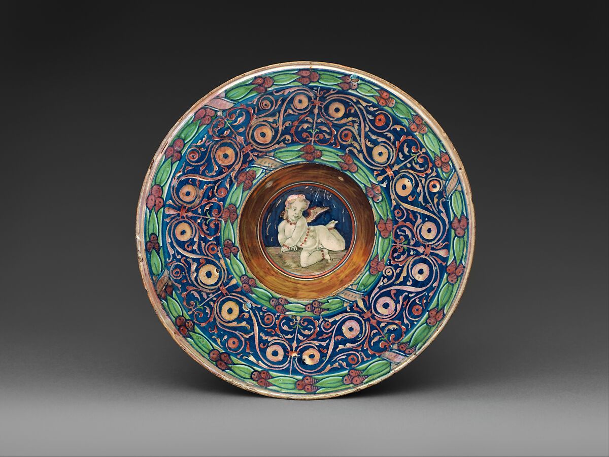 Wide-rimmed bowl with winged putto, Workshop of Maestro Giorgio Andreoli (Italian (Gubbio), active first half of 16th century), Maiolica (tin-glazed earthenware), lustered, Italian, Gubbio 