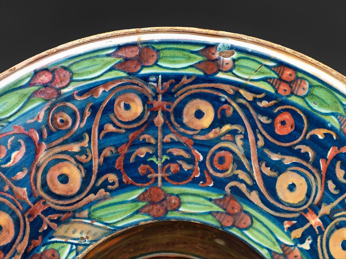 Wide-rimmed bowl with winged putto, Workshop of Maestro Giorgio Andreoli (Italian (Gubbio), active first half of 16th century), Maiolica (tin-glazed earthenware), lustered, Italian, Gubbio