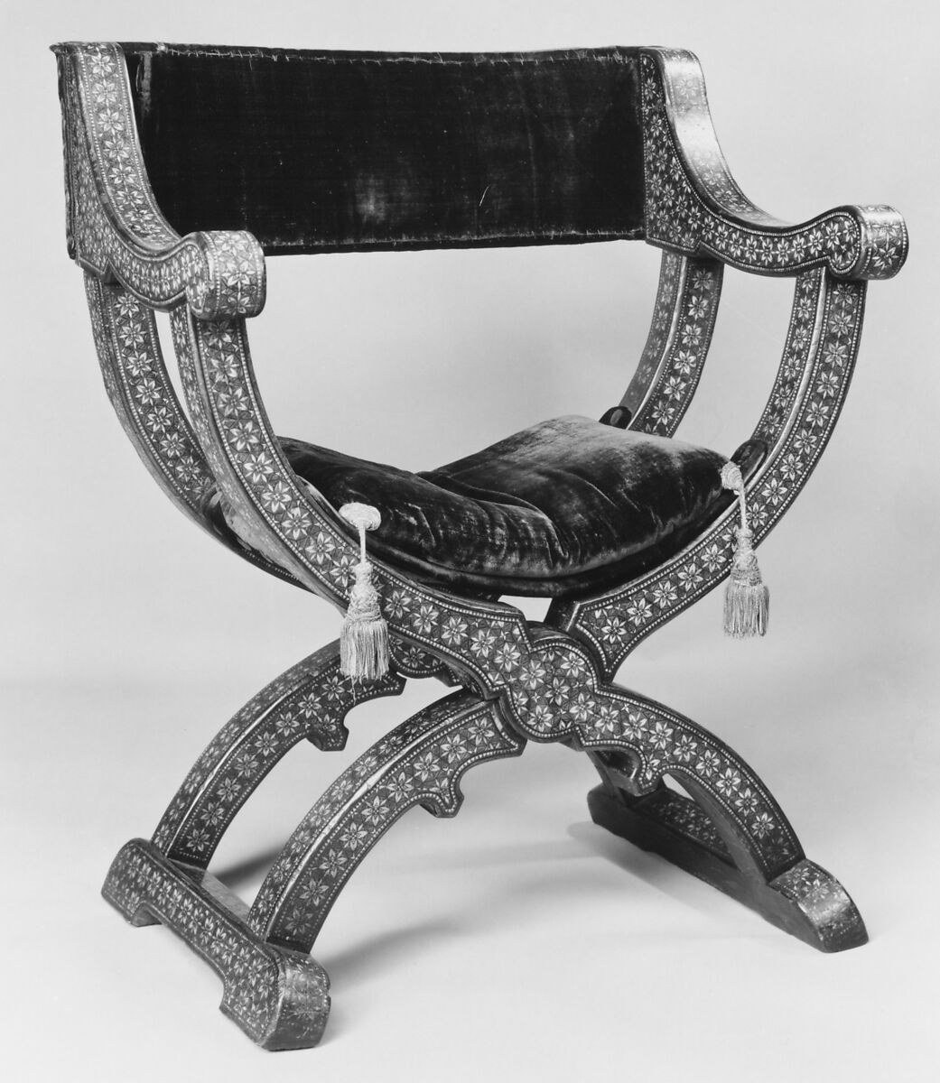 Hip-joint armchair (sillón de cadera or jamuga), Walnut and elm, partly veneered and inlaid with different woods, ivory, bone (camel?) and pewter; covered in silk velvet not original to the armchair, Spanish, Granada