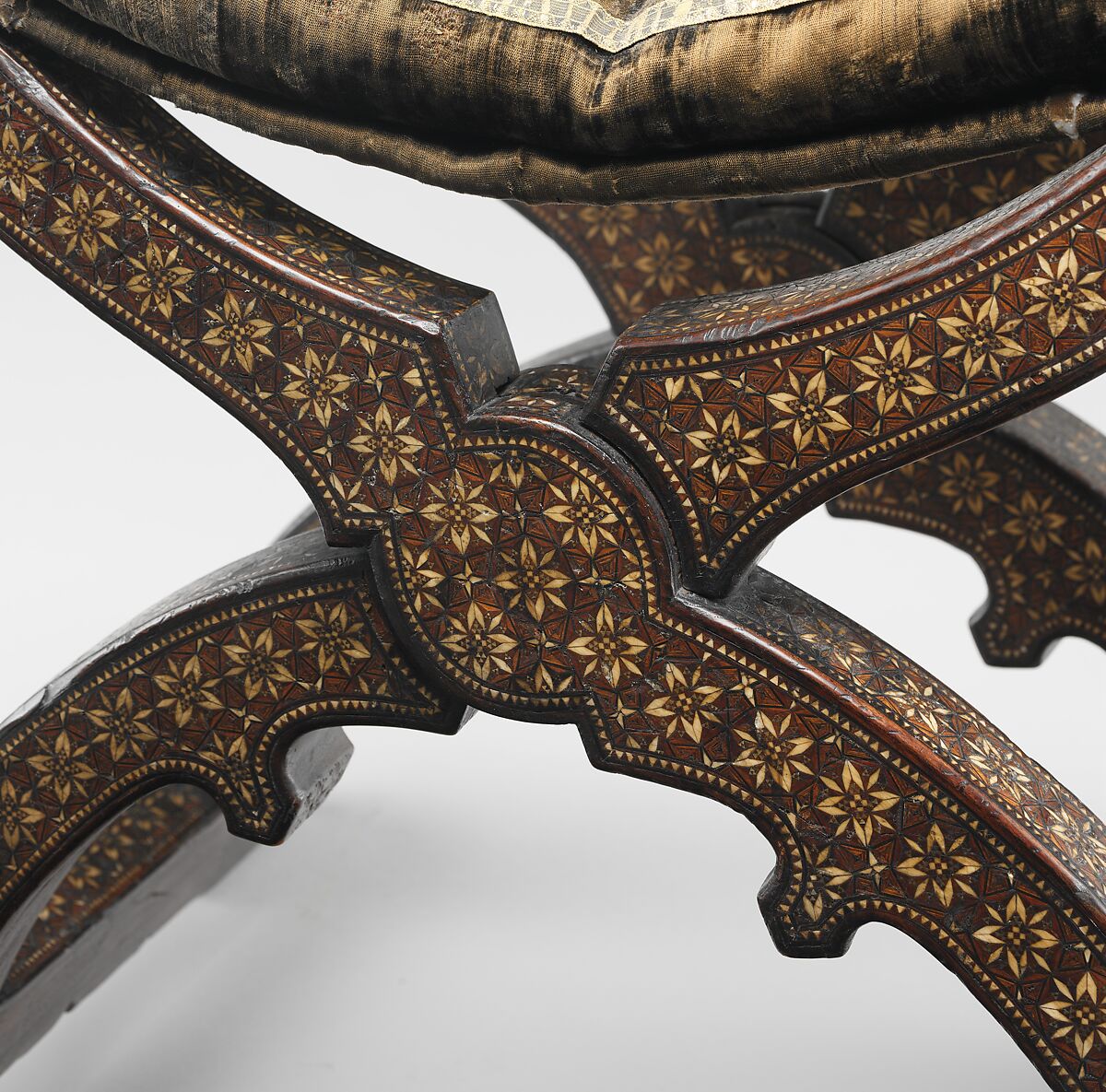Hip-joint armchair (sillón de cadera or jamuga), Walnut and elm, partly veneered and inlaid with different woods, ivory, bone (camel?) and pewter; covered in silk velvet not original to the armchair, Spanish, Granada
