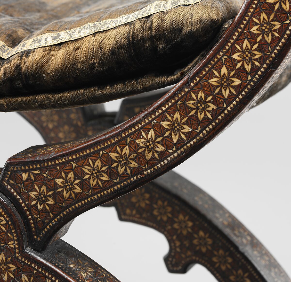 Hip-joint armchair (sillón de cadera or jamuga), Walnut and elm, partly veneered and inlaid with different woods, ivory, bone (camel?) and pewter; covered in silk velvet not original to the armchair, Spanish, Granada