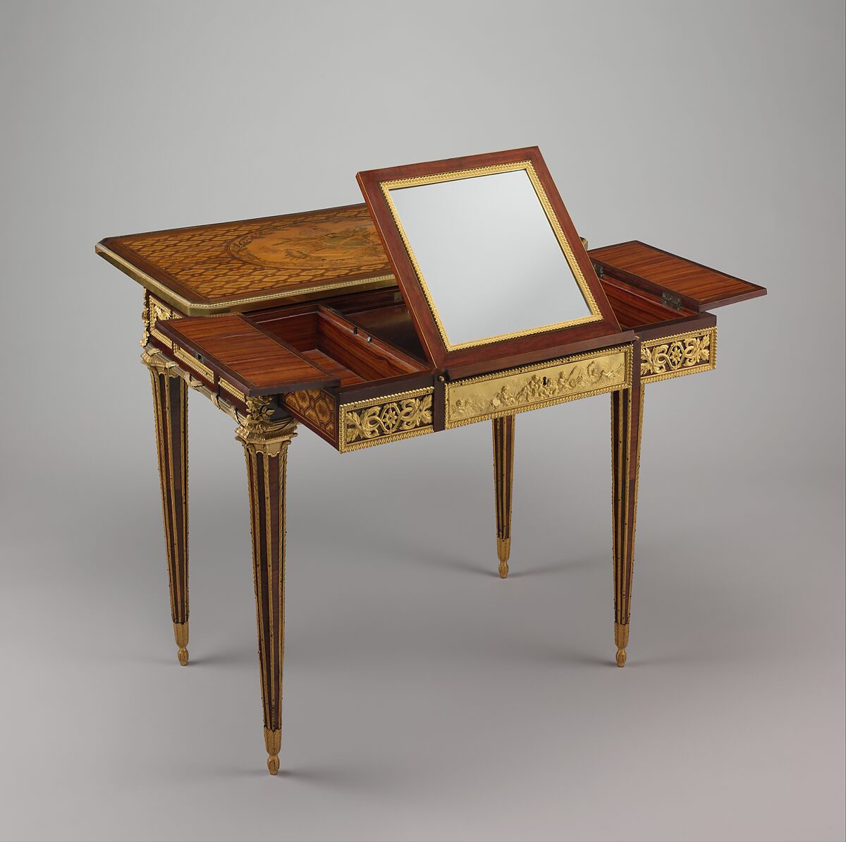 Mechanical table, Jean Henri Riesener (French, Gladbeck, North Rhine-Westphalia 1734–1806 Paris), Oak veneered with mahogany and marquetry of bois satiné, sycamore, holly, ebonized holly fillets, and bayberry, the top with an amaranth border; gilt-bronze mounts; mirror glass; iron and brass fittings; green velvet (not original), French, Paris