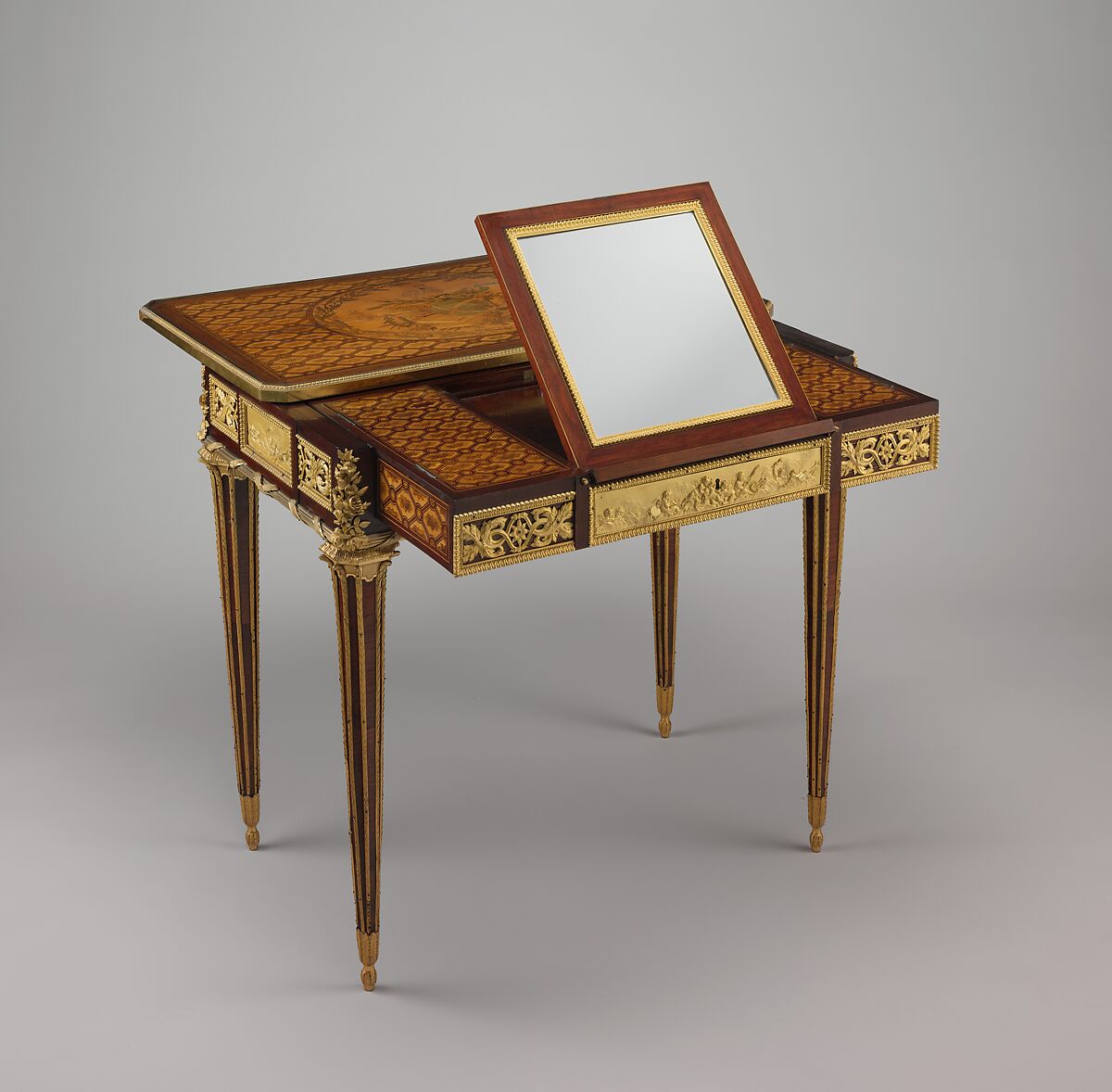 Mechanical table, Jean Henri Riesener (French, Gladbeck, North Rhine-Westphalia 1734–1806 Paris), Oak veneered with mahogany and marquetry of bois satiné, sycamore, holly, ebonized holly fillets, and bayberry, the top with an amaranth border; gilt-bronze mounts; mirror glass; iron and brass fittings; green velvet (not original), French, Paris