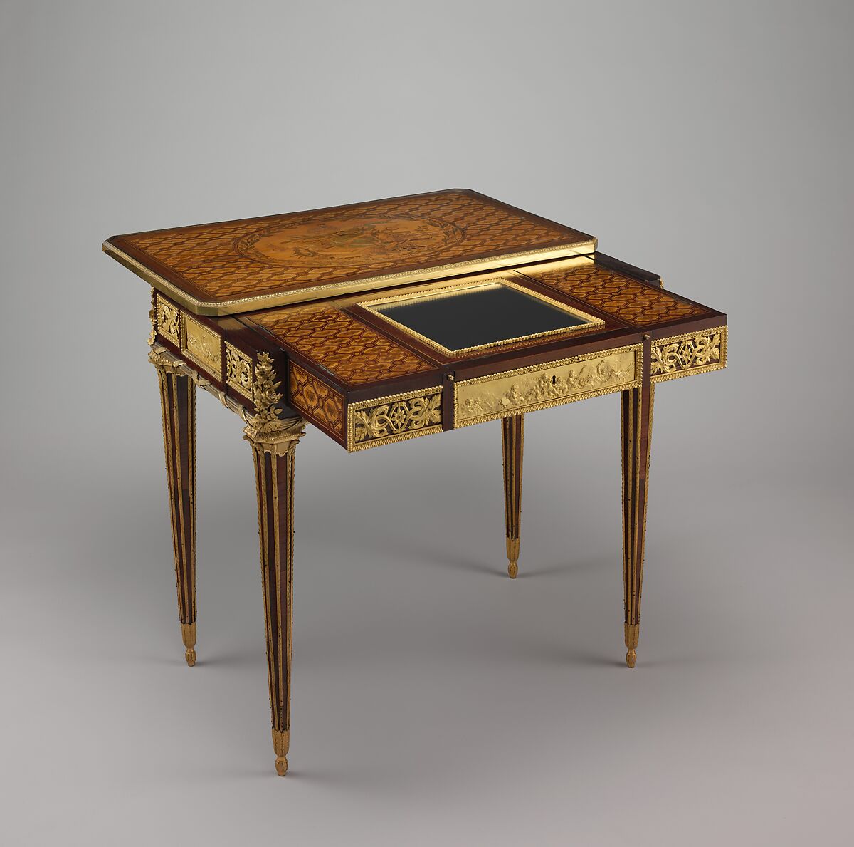 Mechanical table, Jean Henri Riesener (French, Gladbeck, North Rhine-Westphalia 1734–1806 Paris), Oak veneered with mahogany and marquetry of bois satiné, sycamore, holly, ebonized holly fillets, and bayberry, the top with an amaranth border; gilt-bronze mounts; mirror glass; iron and brass fittings; green velvet (not original), French, Paris