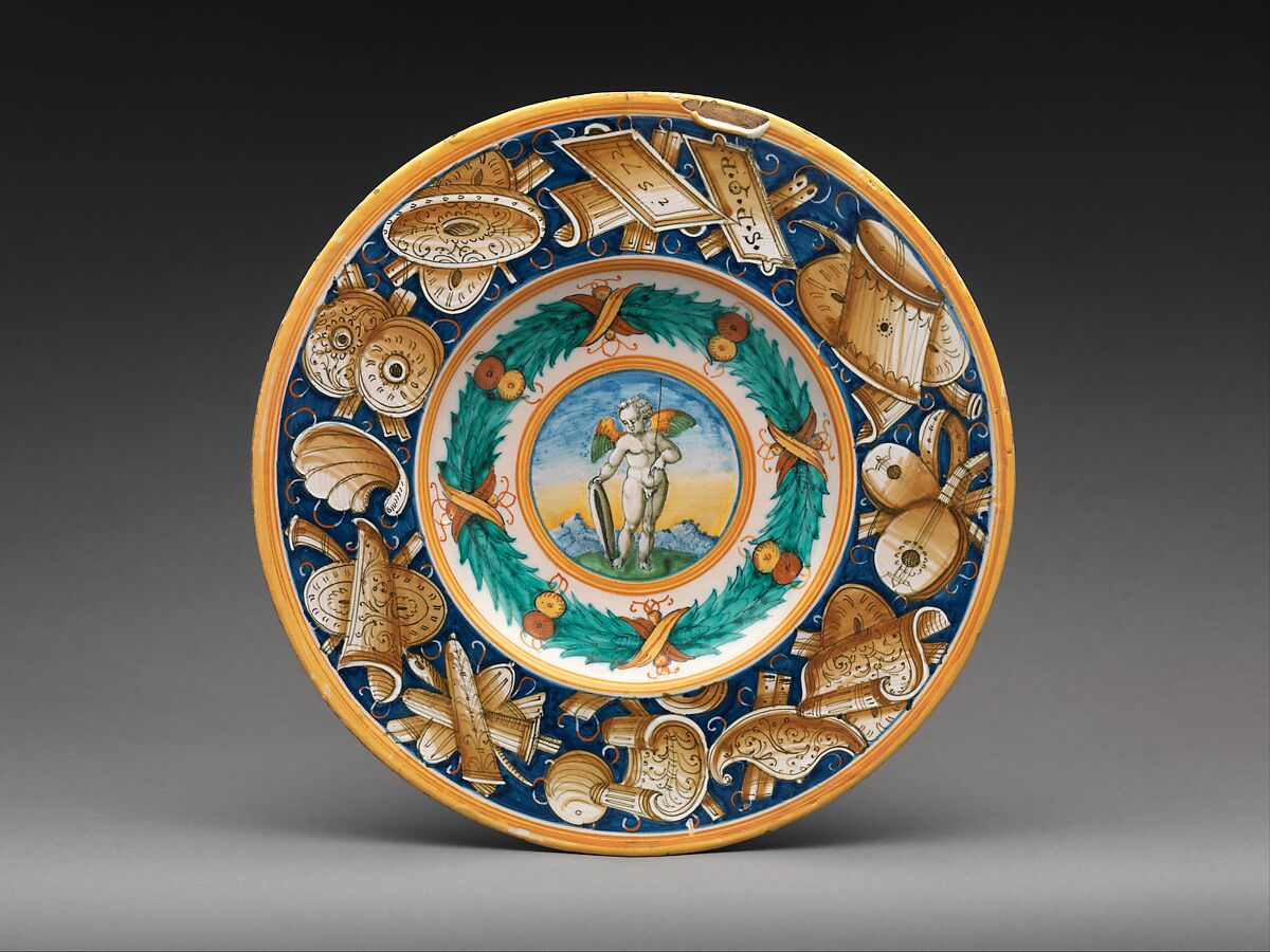 Dish with winged putto, Border decoration based on designs by Cipriano Piccolpasso (Italian, active mid-16th century), Maiolica (tin-glazed earthenware), Italian, Duchy of Urbino (Pesaro or Castel Durante) 