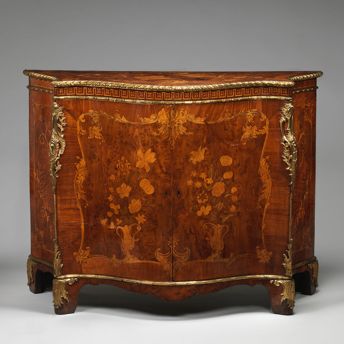 Commode, Attributed to John Mayhew (British, 1736–1811), Pine veneered with satinwood, mahogany, burl, yew, and purplewood; gilt bronze, British