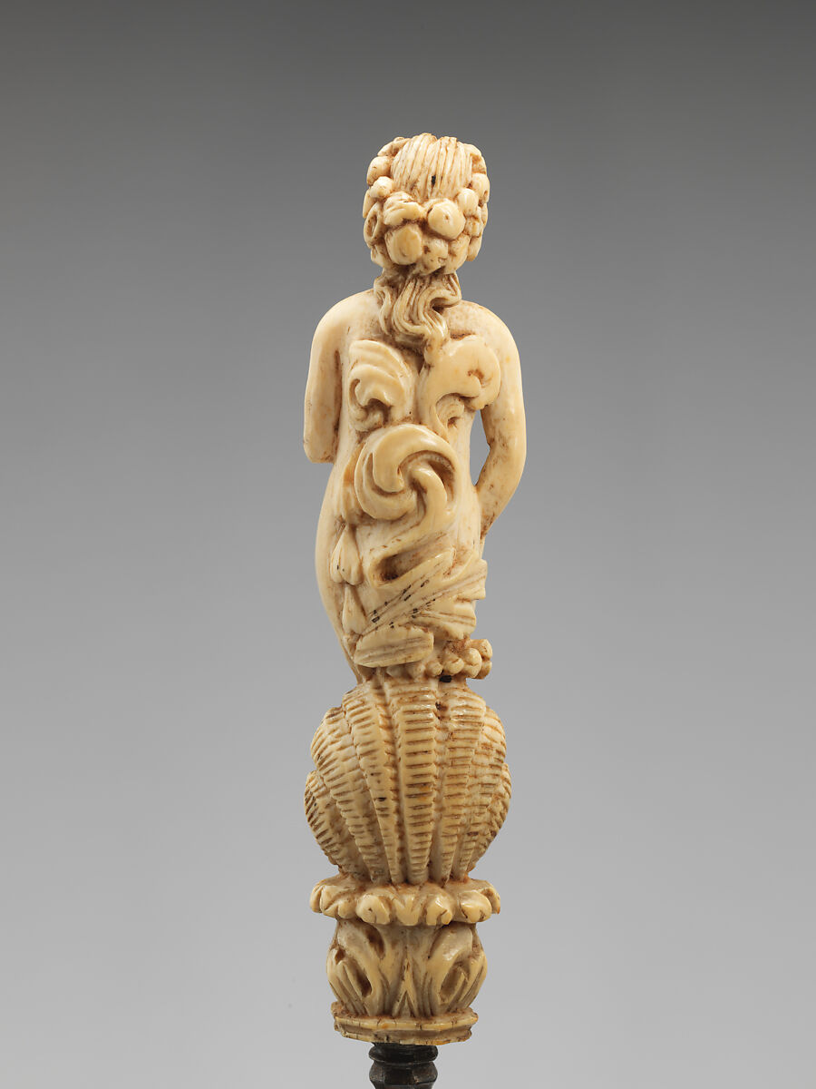 Knife with carved handle of nude female with crescent in hair standing in a half shell holding a swag, Steel gilt, ivory, Italian