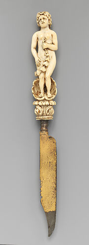Knife with carved handle of nude female with crescent in hair standing in a half shell holding a swag