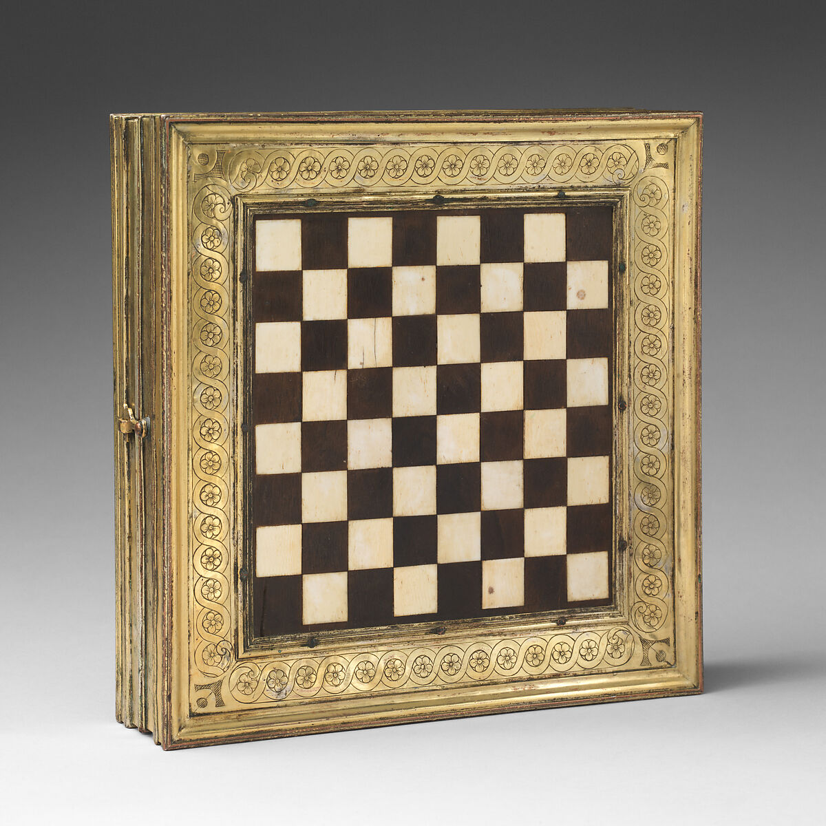 Chess and tric-trac board, Copper-gilt, walnut, ivory, mother-of-pearl, serpentine, rosso antico marble, Spanish, Castile
