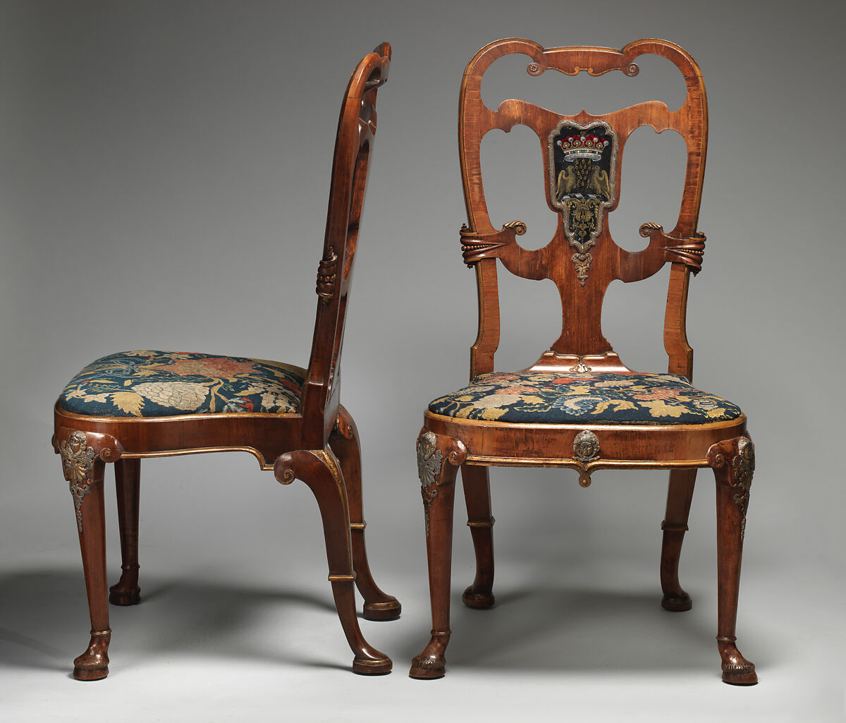 Pair of side chairs, Attributed to Thomas How (British, active 1710–33), Walnut and walnut veneer, parcel-gilt, the seat rails of beech; gilded lead mounts on the knees and front rail; verre églomisé panel mounted on the splat; covered in contemporary tent stitch embroidery on canvas needlework not original to the chair, British 