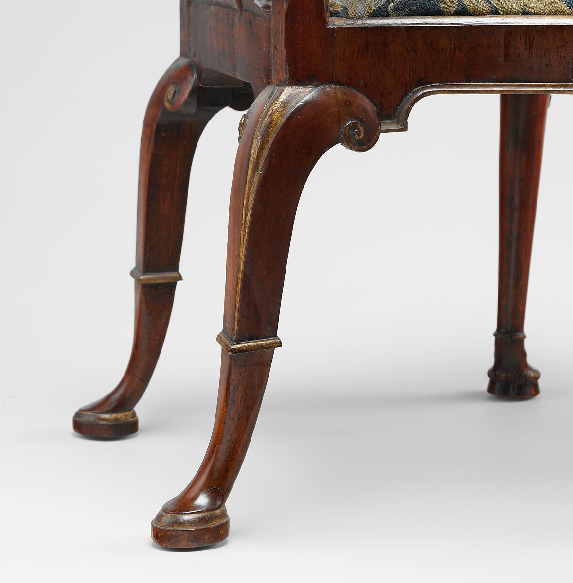 Pair of side chairs, Attributed to Thomas How (British, active 1710–33), Walnut and walnut veneer, parcel-gilt, the seat rails of beech; gilded lead mounts on the knees and front rail; verre églomisé panel mounted on the splat; covered in contemporary tent stitch embroidery on canvas needlework not original to the chair, British