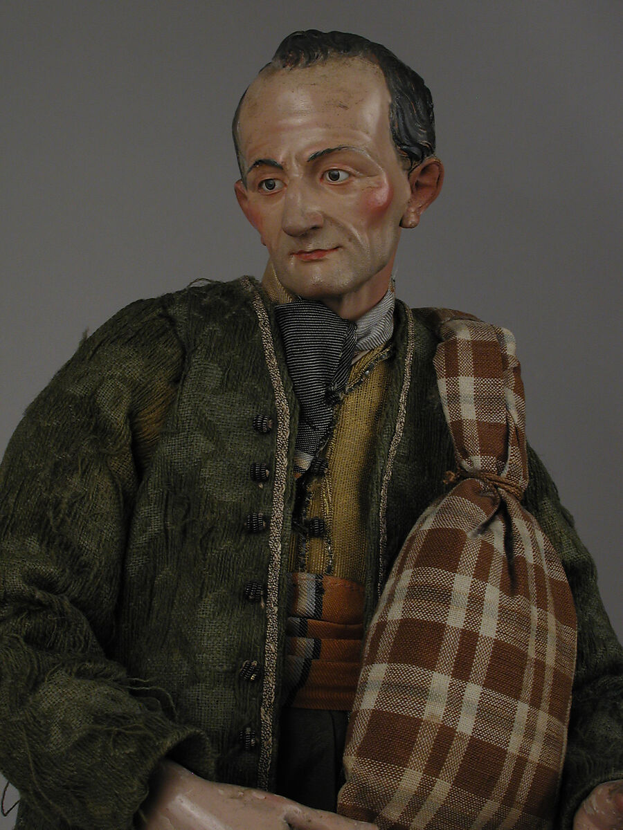 Shepherd with lamb in shoulder bag, Polychromed terracotta head and lamb; wooden limbs; body of wire wrapped in tow; silk, cotton and suede garments; silver metal coiled wire buttons and gold vest, Italian, Naples