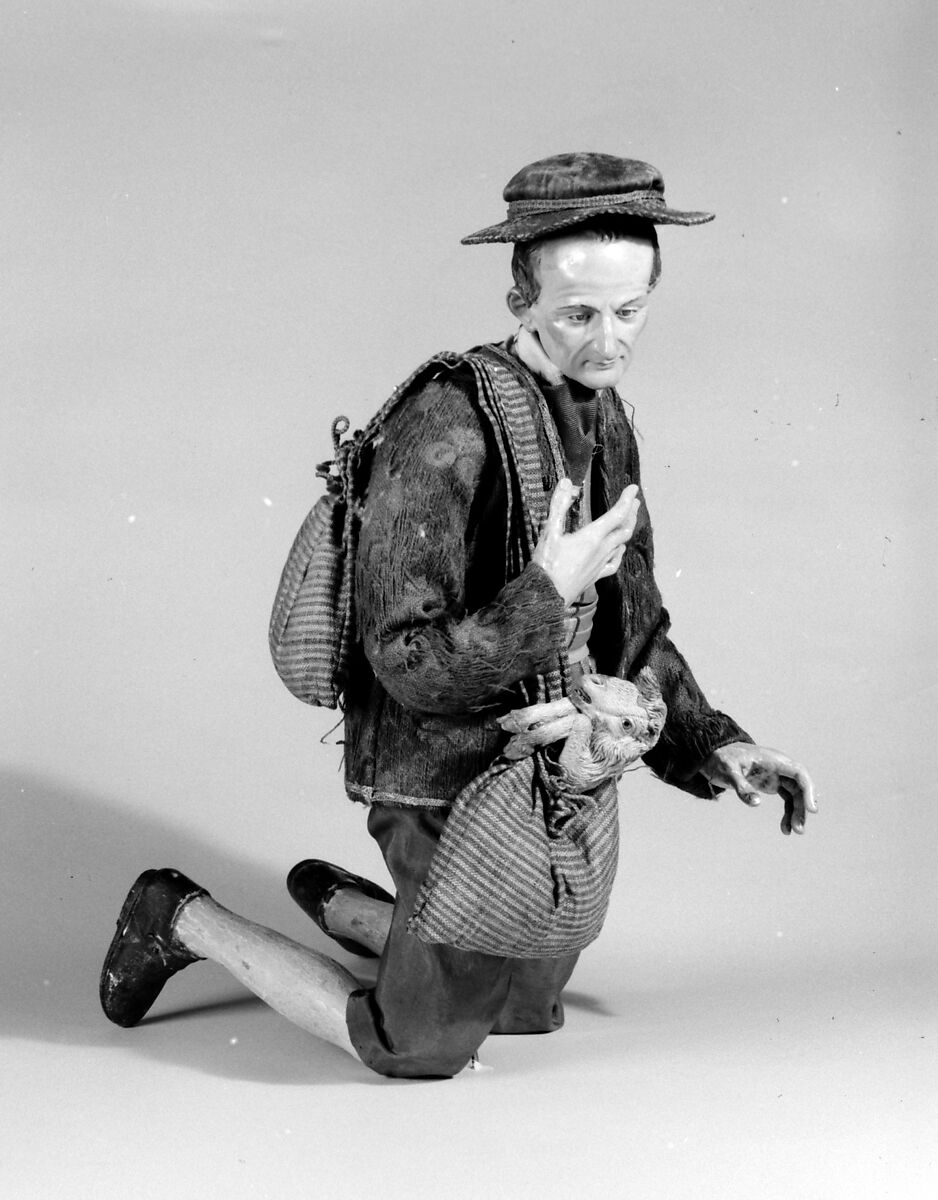 Shepherd with lamb in shoulder bag, Polychromed terracotta head and lamb; wooden limbs; body of wire wrapped in tow; silk, cotton and suede garments; silver metal coiled wire buttons and gold vest, Italian, Naples