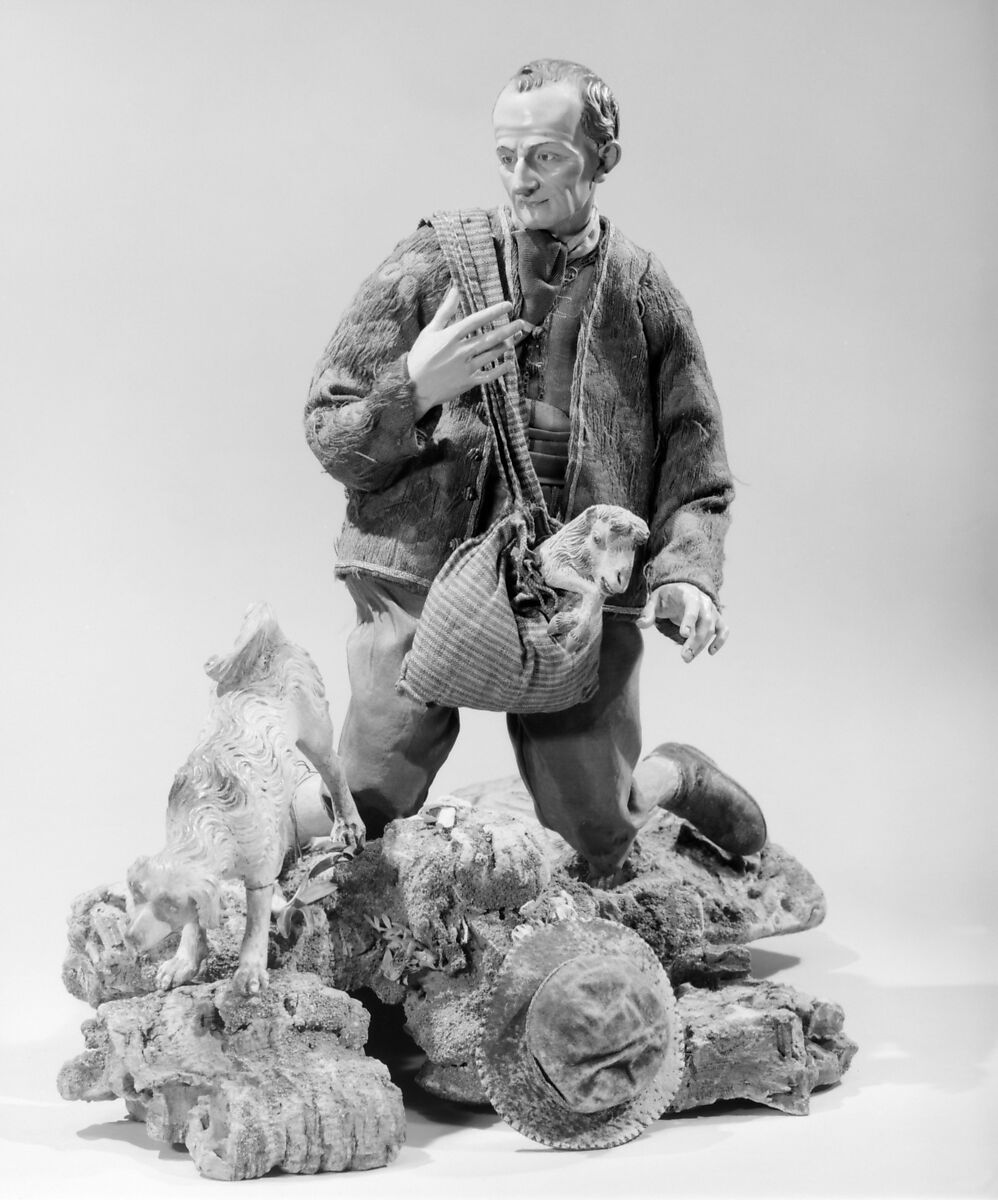 Shepherd with lamb in shoulder bag, Polychromed terracotta head and lamb; wooden limbs; body of wire wrapped in tow; silk, cotton and suede garments; silver metal coiled wire buttons and gold vest, Italian, Naples
