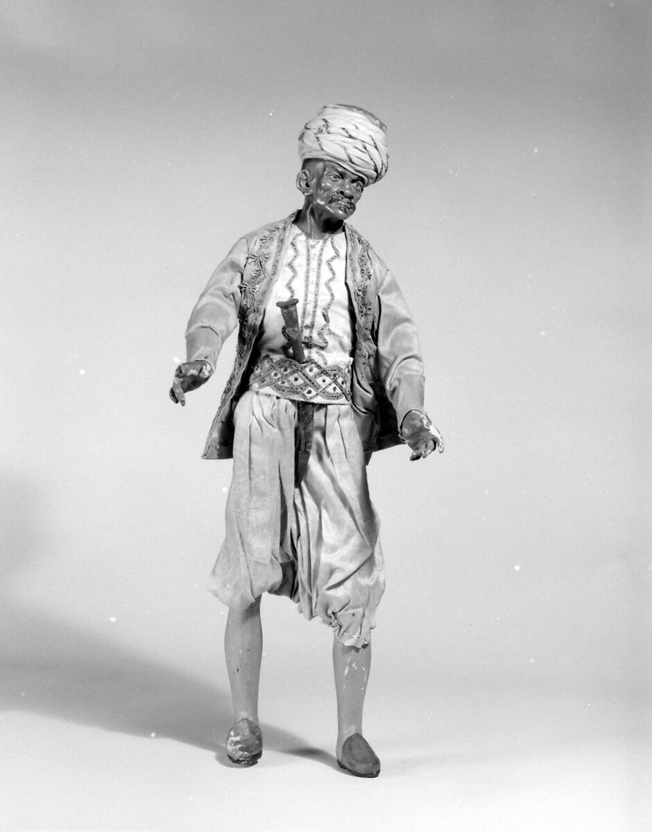 King's attendant, Giovanbattista Polidoro (Italian), Polychromed terracotta head and wooden limbs; body of wire wrapped in tow; silk garments with silver and gold metallic thread; silk and cotton turban; metal dagger in leather sheath, Italian, Naples