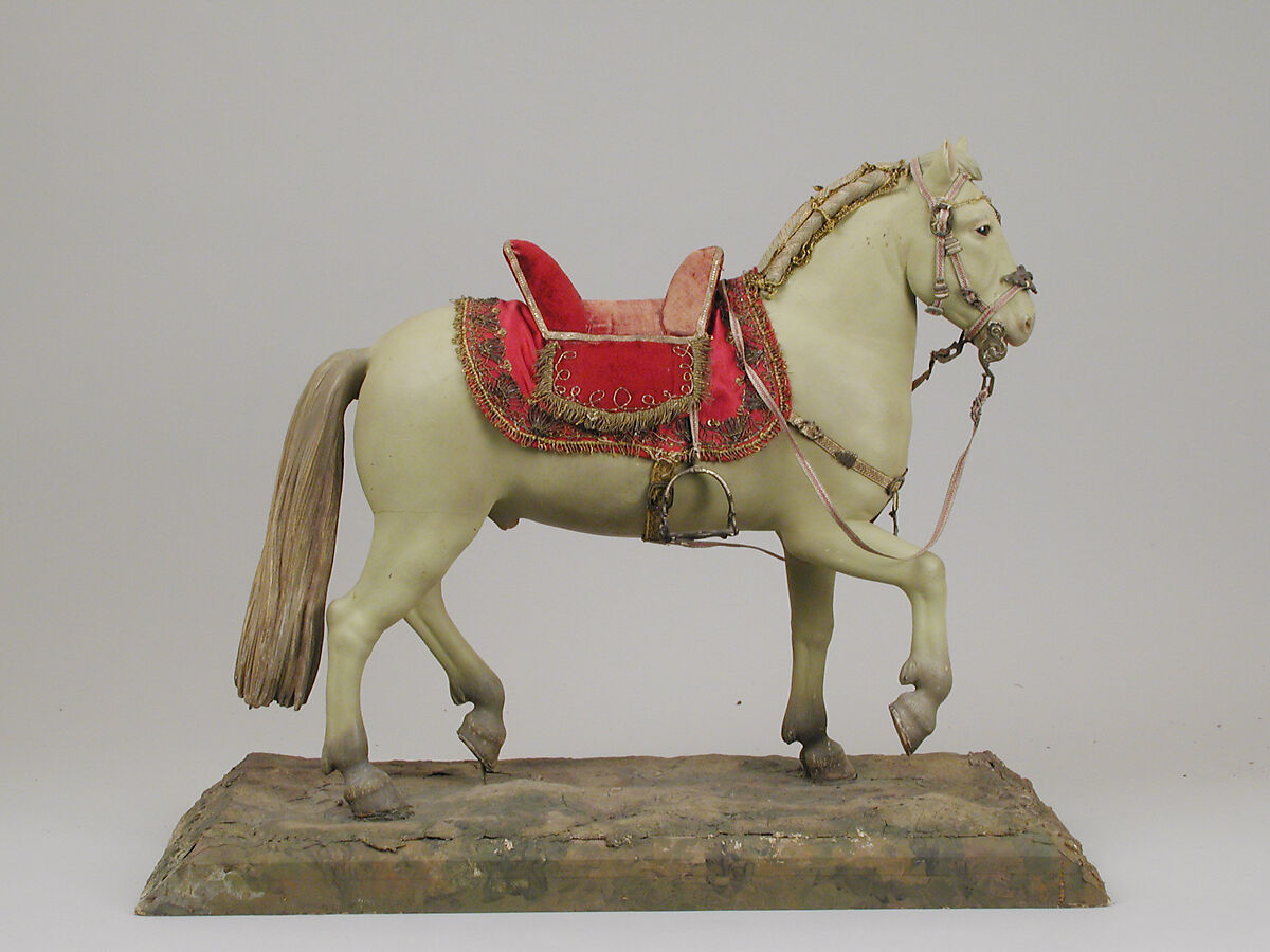 Horse, Polychromed terracotta body; wooden legs and tail; velvet covered wooden saddle; satin saddle blanket bordered with metallic thread; gold neck strap and gold threaded girth with gilt metal buckles; silver braided martingale; gold braided mane; silver braided bridle; silver stirrups and silver braided reins, Italian, Naples 