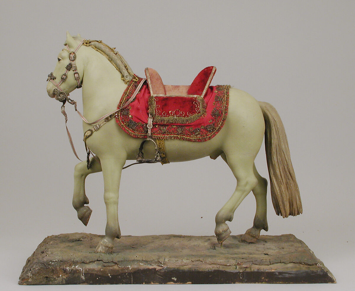 Horse, Polychromed terracotta body; wooden legs and tail; velvet covered wooden saddle; satin saddle blanket bordered with metallic thread; gold neck strap and gold threaded girth with gilt metal buckles; silver braided martingale; gold braided mane; silver braided bridle; silver stirrups and silver braided reins, Italian, Naples