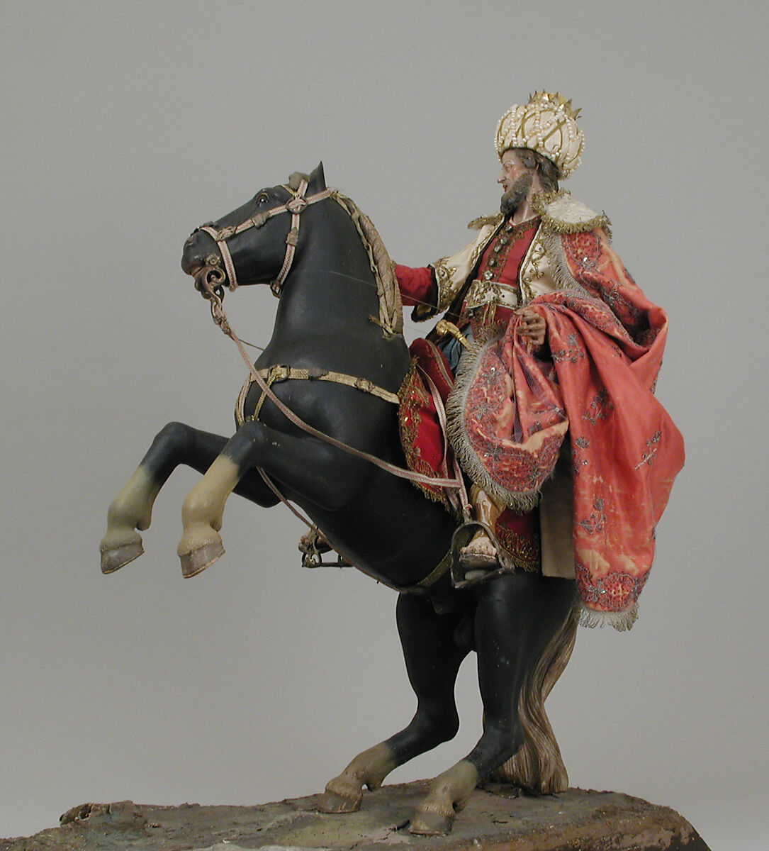 Black horse, Polychromed terracotta body; wooden legs and tail; velvet covered wooden saddle; satin saddle blanket with metallic thread; gold braided girth and neck strap with silver buckles; silver braided martingale, bridle and reins; gold braided mane; silver stirrups, Italian, Naples