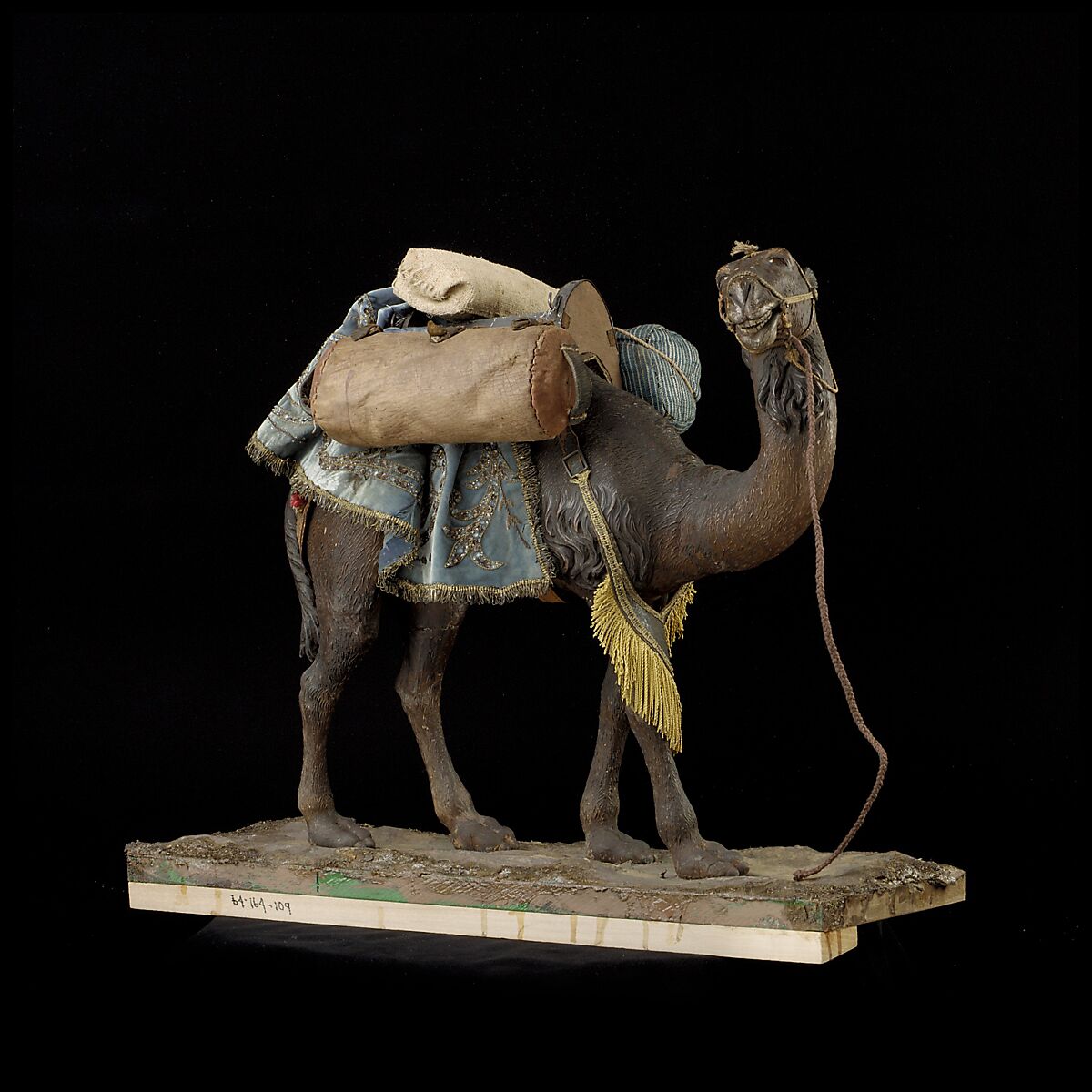 Camel, Polychromed wooden body covered with stucco; wooden saddle and leather girth straps; burlap cushion and leather saddlebags, Italian, Naples 