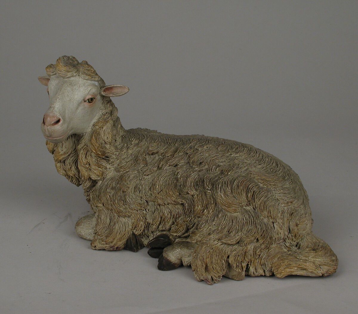 Seated sheep, Polychromed terracotta body and wooden ears, Italian, Naples