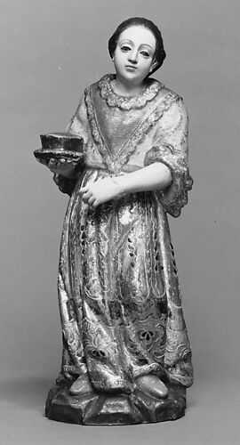 Standing woman with a bowl on a plate from a nativity