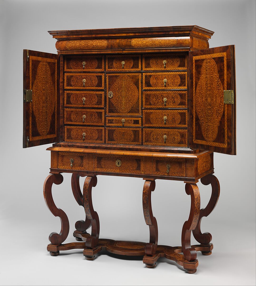 Cabinet on stand, Pine veneered with marquetry of walnut, burl walnut, holly; oak drawers; walnut legs; brass hardware, some of it replaced, British