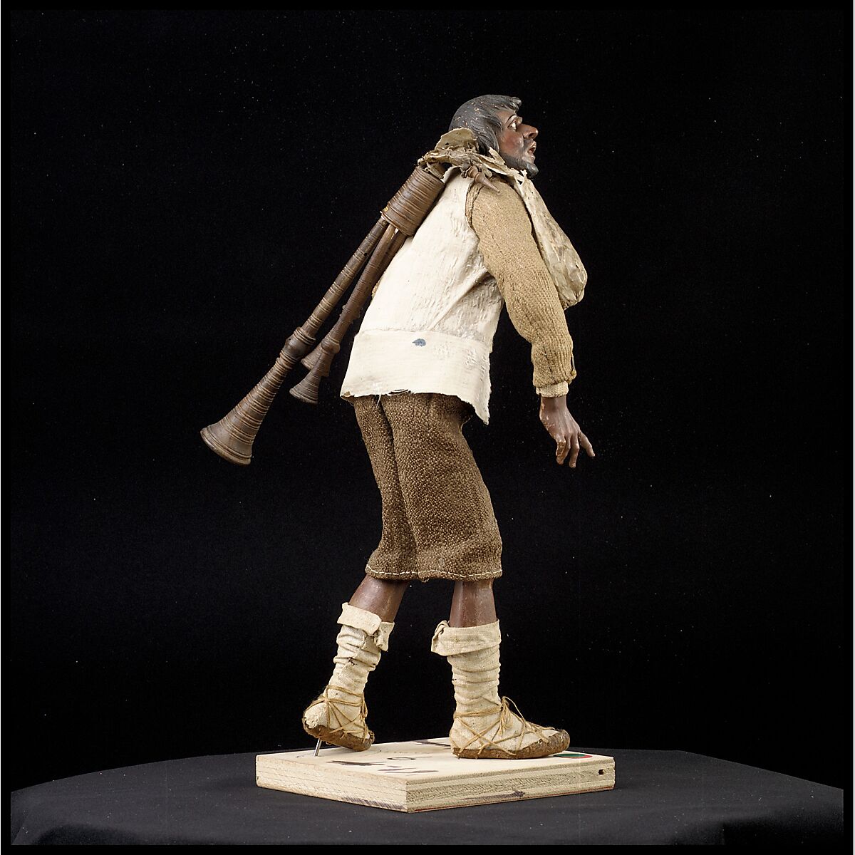 Man carrying bagpipes, Polychromed terracotta and wood; cloth, straw and leather, Italian, Naples