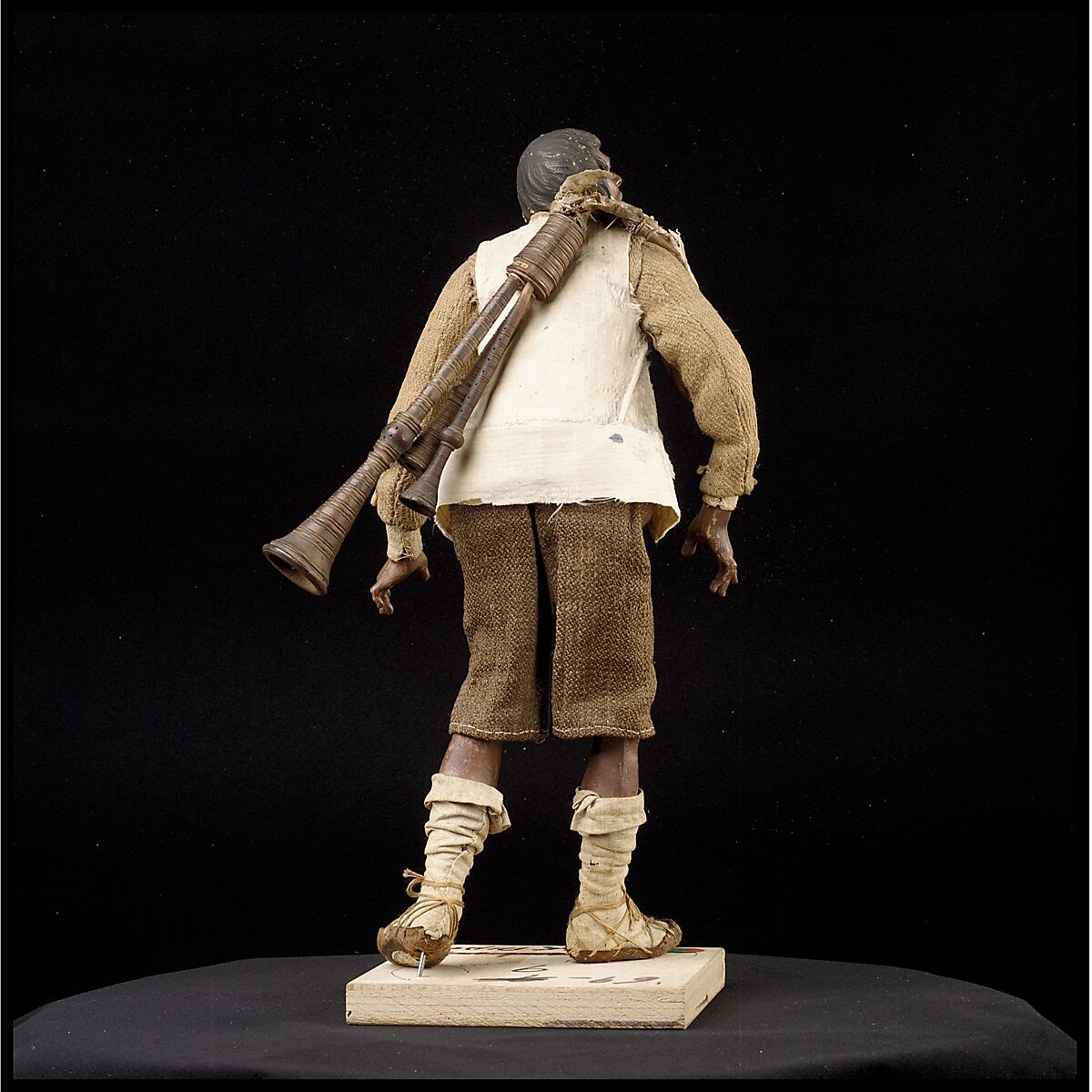 Man carrying bagpipes, Polychromed terracotta and wood; cloth, straw and leather, Italian, Naples