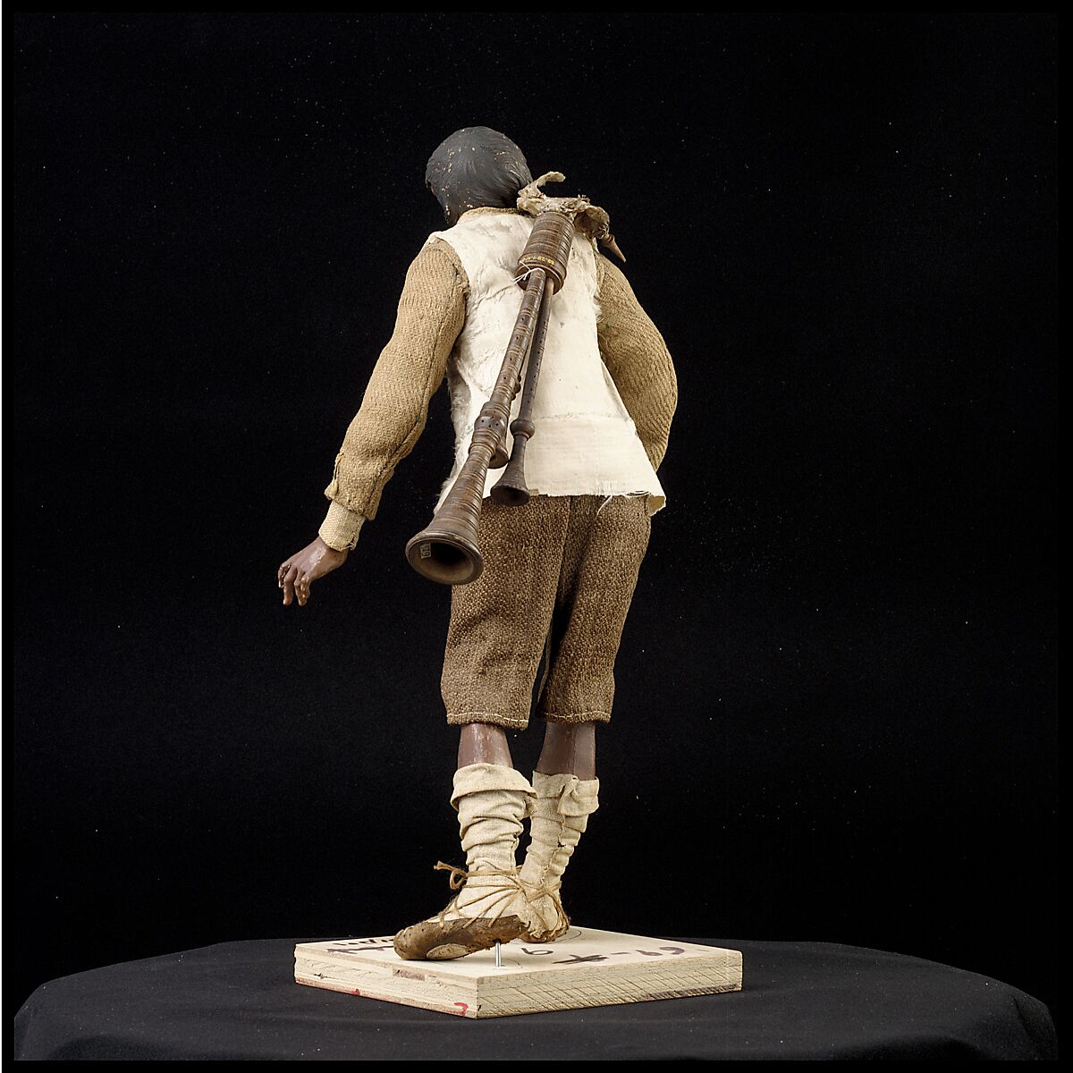 Man carrying bagpipes, Polychromed terracotta and wood; cloth, straw and leather, Italian, Naples