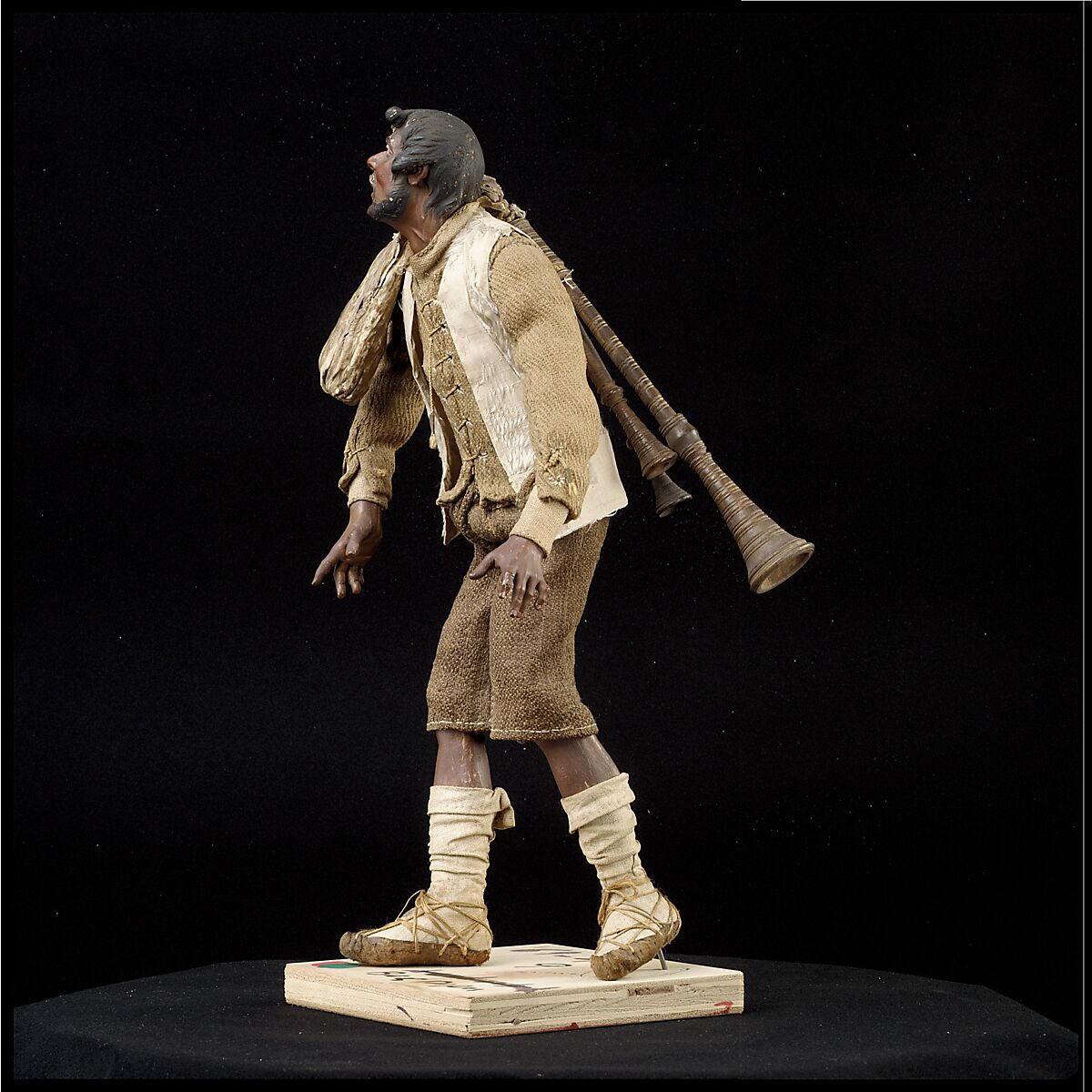 Man carrying bagpipes, Polychromed terracotta and wood; cloth, straw and leather, Italian, Naples
