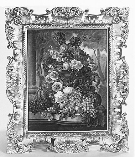 An urn overflowing with fruit and flowers