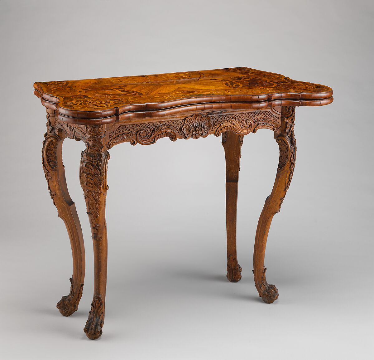 Card table, Carved walnut frame; pine top with marquetry of walnut, figured walnut, boxwood, alder burl, birch, olive wood, plum, padauk wood, yew, green-stained poplar, and other marquetry woods; lined with modern velvet; iron fittings, German, Bamberg