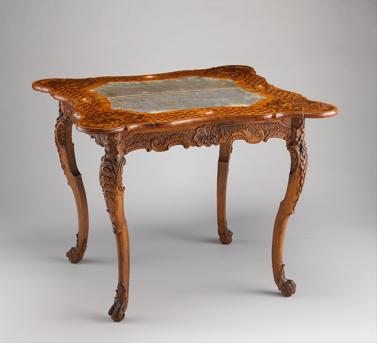 Card table, Carved walnut frame; pine top with marquetry of walnut, figured walnut, boxwood, alder burl, birch, olive wood, plum, padauk wood, yew, green-stained poplar, and other marquetry woods; lined with modern velvet; iron fittings, German, Bamberg 