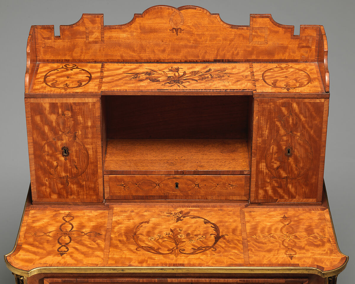 Small desk, Satinwood, purpleheart, padouk and other marquetry woods on oak substrate; mahogany interior; brass mounts; leather-lined writing surface, British