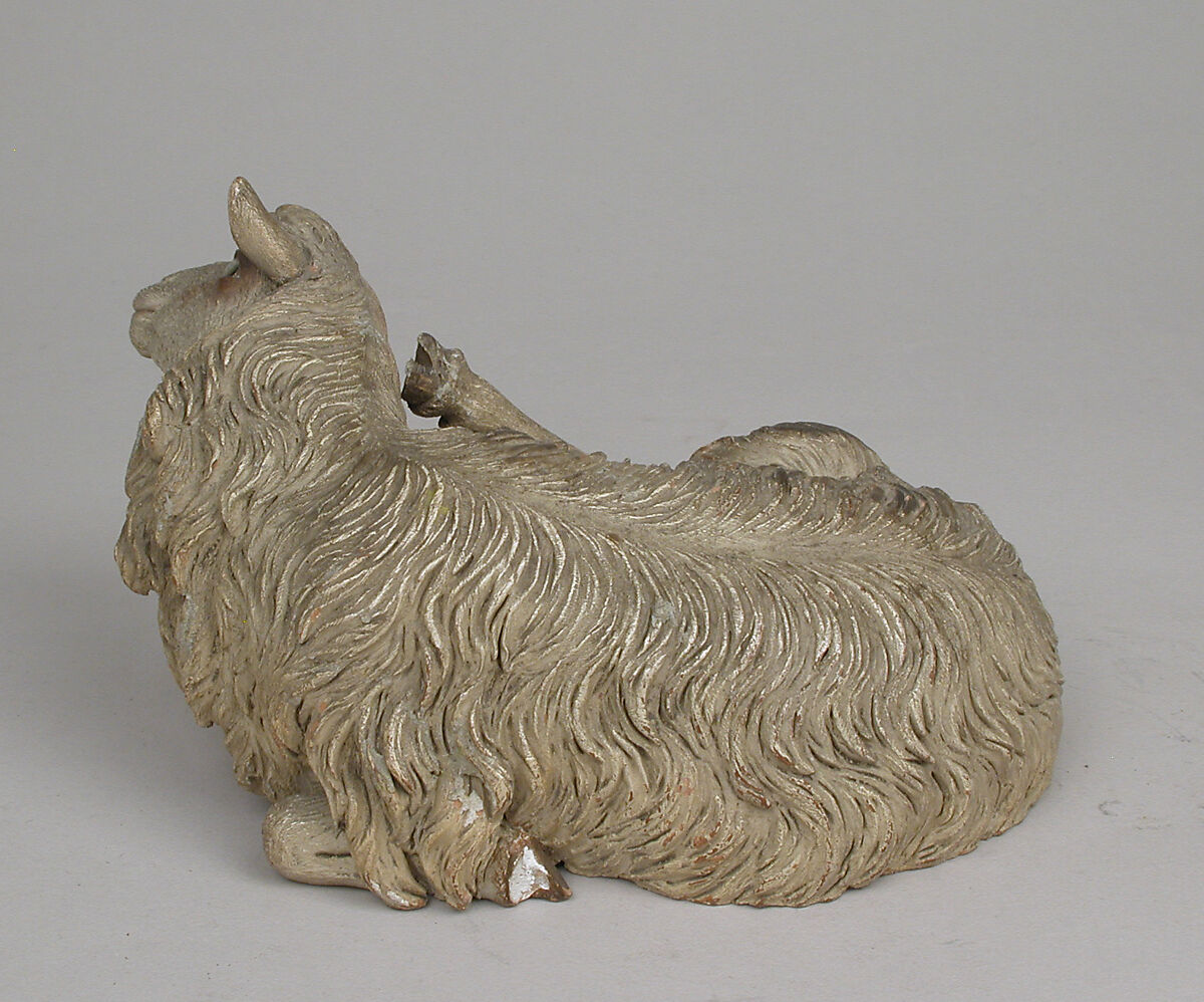 Reclining sheep, Polychromed terracotta body; wooden ears and raised leg, Italian, Naples